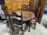Round Table with (2) Leaves and (4) Ladder Back Chairs, with Plaid Seat Cushions.