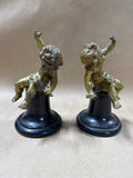 Solid Brass Cherub Putti Figurines on Black Turned Wood Pedestals - Pair