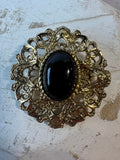 Ornate Gold Tone Filigree Brooch with Black Lucite Cabochon