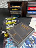 Lot of 8 Assorted Atari 2600 & 7800 Games with Manuals in 8-Cartridge Musicmate Modular Storage Rack (A)