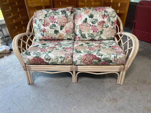 Wicker Sofa with Floral Cushions