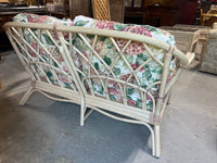 Wicker Sofa with Floral Cushions
