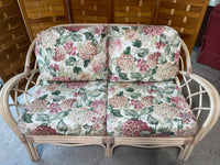 Wicker Sofa with Floral Cushions