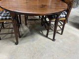 Round Table with (2) Leaves and (4) Ladder Back Chairs, with Plaid Seat Cushions.