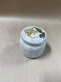 Speckled Pottery Jar With Floral Lid