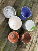 (G)Lot of Five Planters and Six 6” Plastic Saucers
