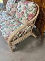 Wicker Sofa with Floral Cushions