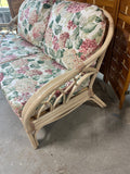 Wicker Sofa with Floral Cushions