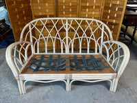Wicker Sofa with Floral Cushions