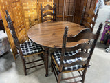 Round Table with (2) Leaves and (4) Ladder Back Chairs, with Plaid Seat Cushions.