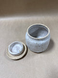 Speckled Pottery Jar With Floral Lid