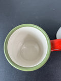 Pair of Nancy Thomas Celebrate Santa Coffee Mugs (A)