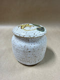 Speckled Pottery Jar With Floral Lid