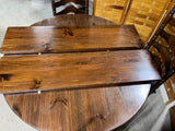 Round Table with (2) Leaves and (4) Ladder Back Chairs, with Plaid Seat Cushions.