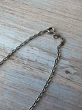 Silver Tone Textured Flower Pendant Necklace with Black Stone
