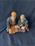 Japanese Hakata Urasaki Kneeling Elderly Couple Book Needlework Figurine