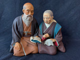 Japanese Hakata Urasaki Kneeling Elderly Couple Book Needlework Figurine