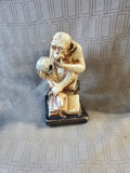 Thinking Monkey Sitting on Stack of Books Holding Skull Statue