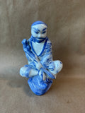 Blue and White Porcelain Seated Man Figurine