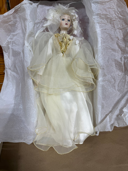 Whimsical Doll with Feathers and Gold Trim