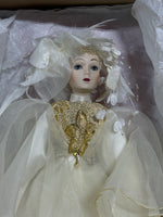 Whimsical Doll with Feathers and Gold Trim