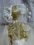 Whimsical Doll with Feathers and Gold Trim