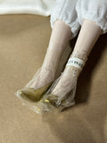Whimsical Doll with Feathers and Gold Trim