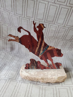 Metal Bull-Riding Sculpture on Stone