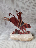 Metal Bull-Riding Sculpture on Stone