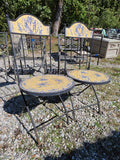 Two Black Metal Folding Chairs w/Yellow and Blue Mosaic Tile Seats